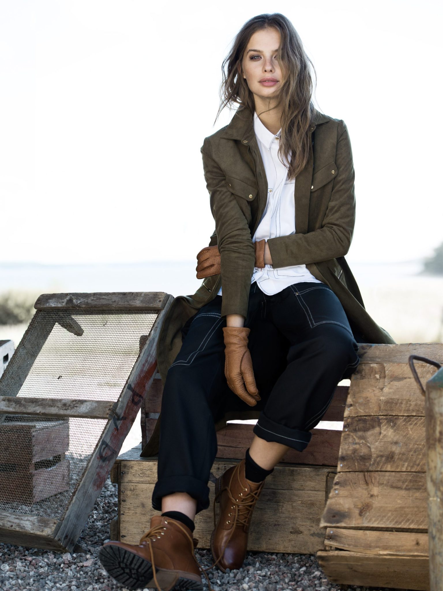a woman sitting on a wooden platform