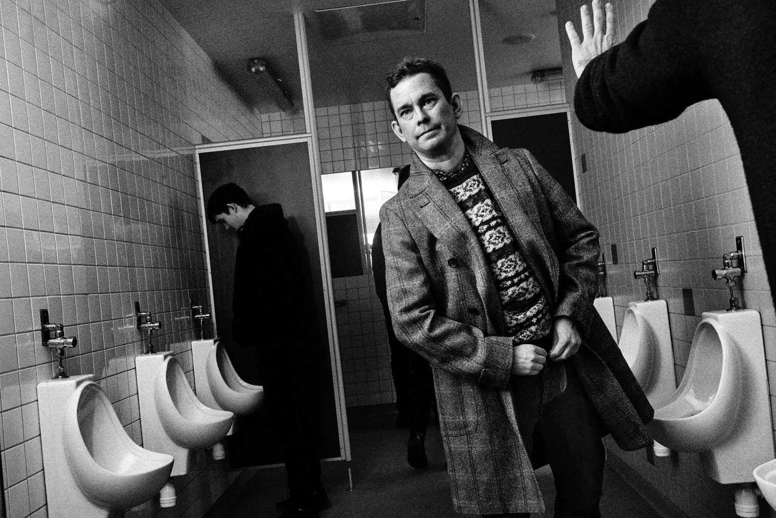 a man standing in a public bathroom