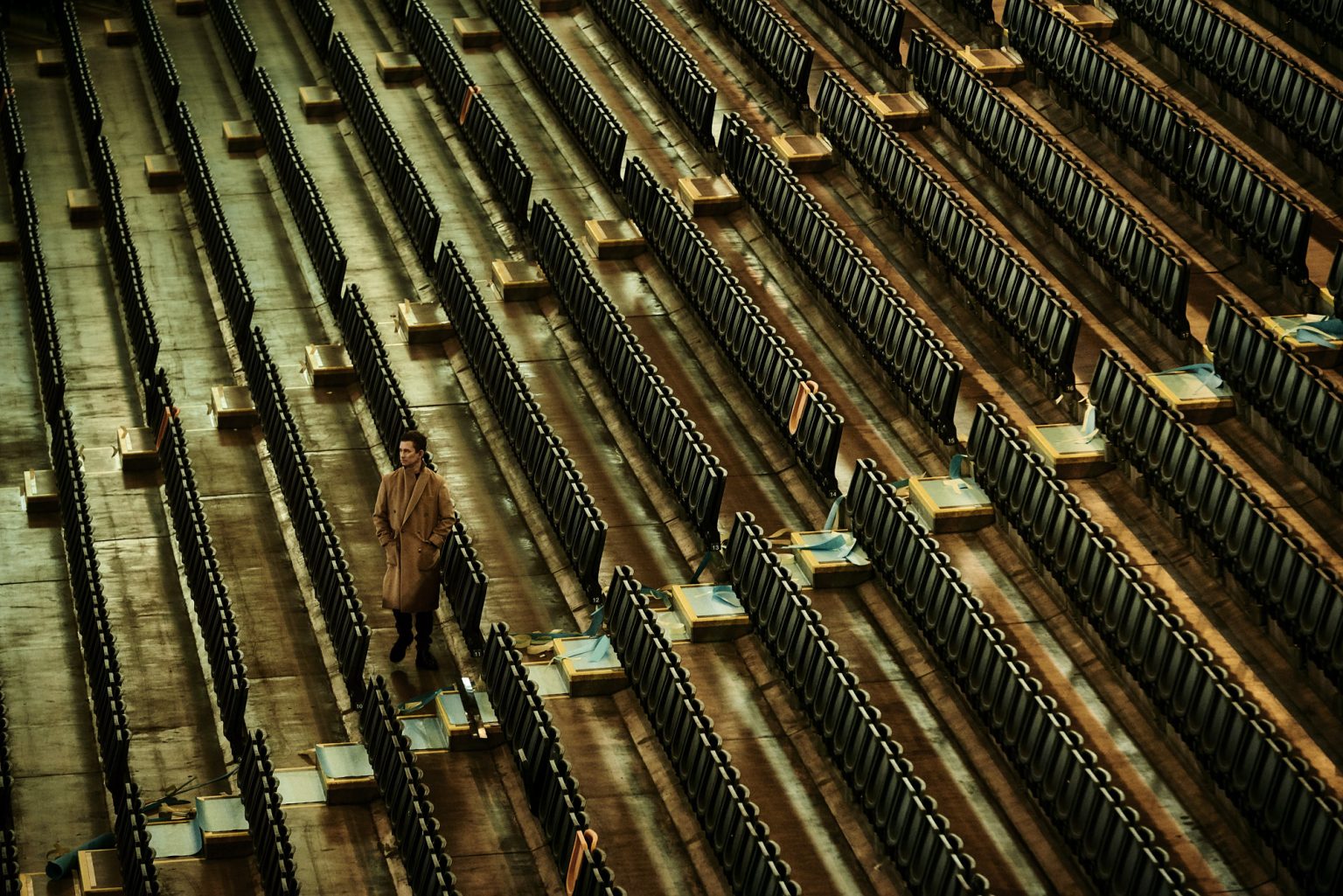 a man standing in a row of chairs