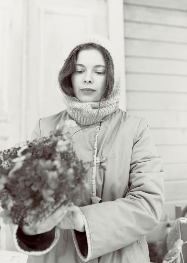 a woman holding a bouquet of flowers