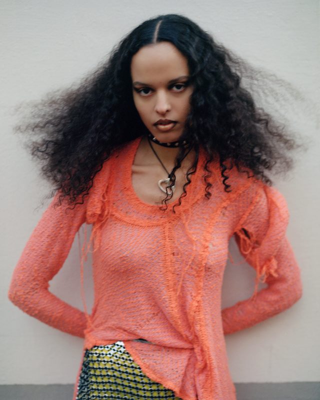 a woman with long curly hair