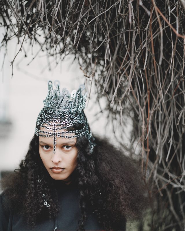 a woman with a crown and hair piece