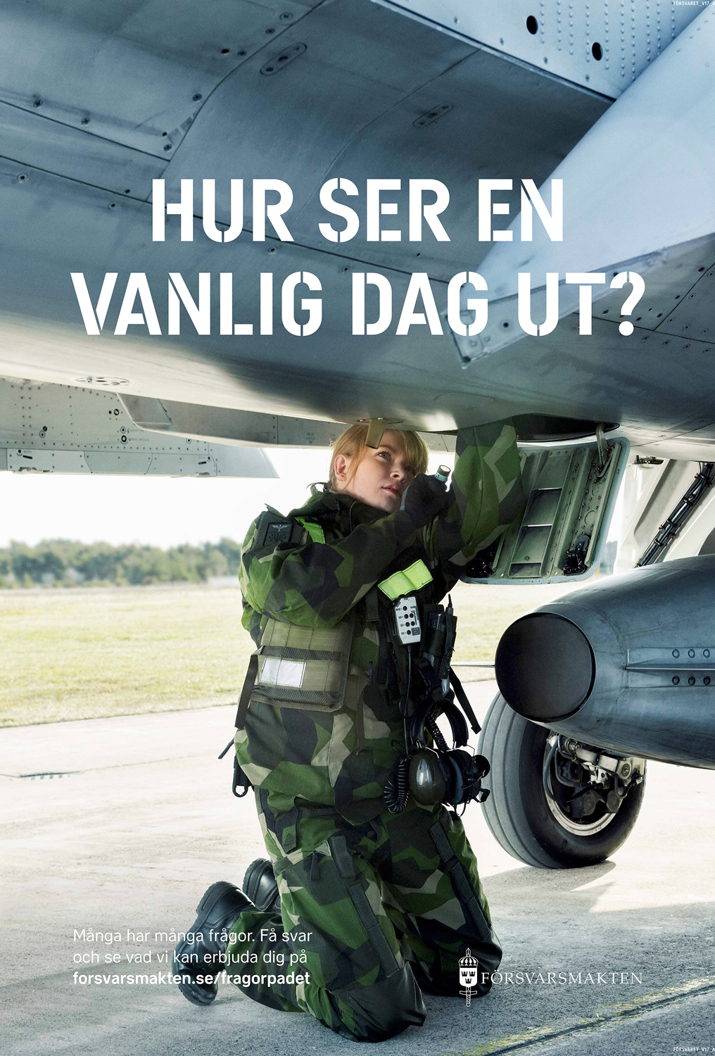 a woman in military uniform under a plane
