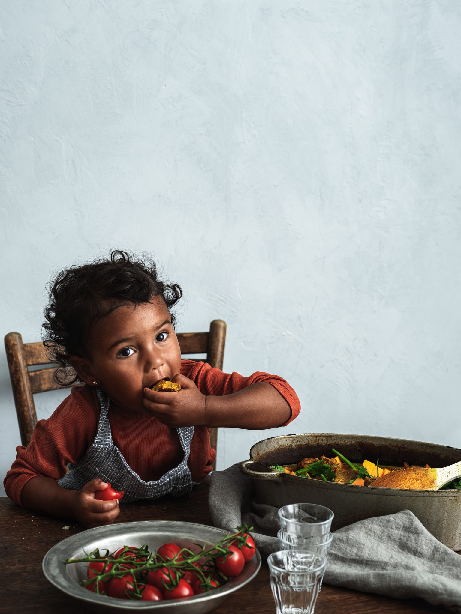 a child eating food at a table