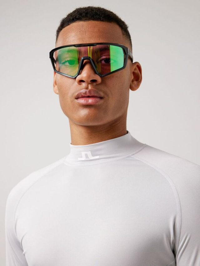 a man wearing sunglasses and white shirt