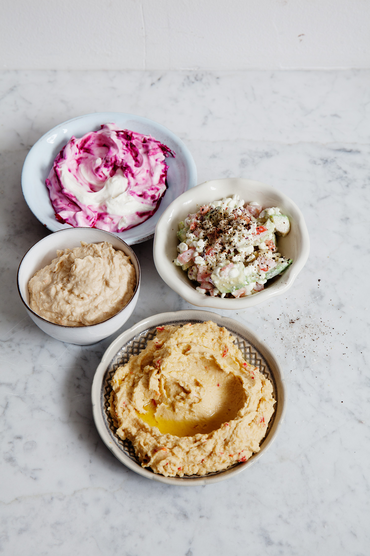 a group of bowls of dips