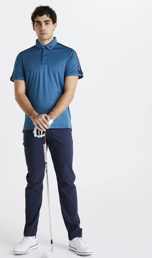a man wearing a blue shirt and blue pants