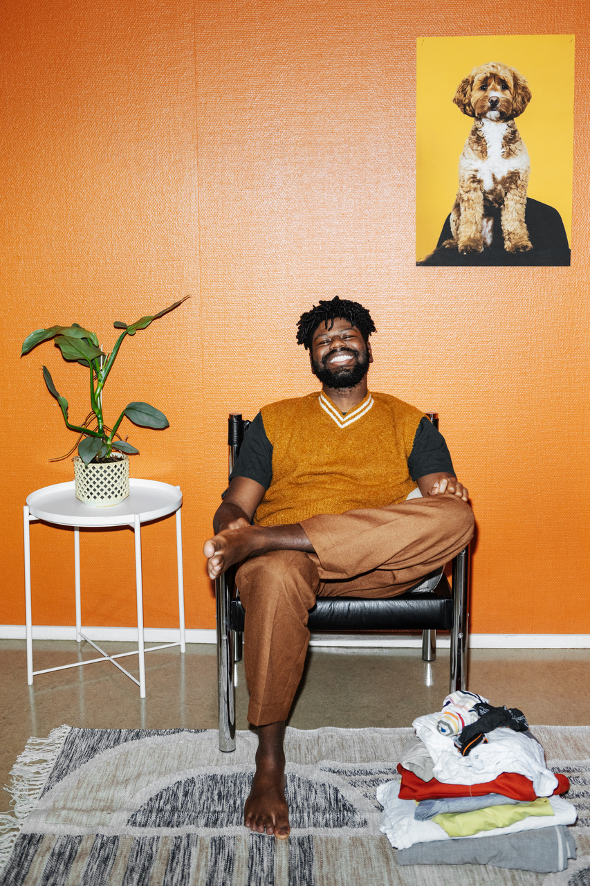a man sitting in a chair with his legs crossed