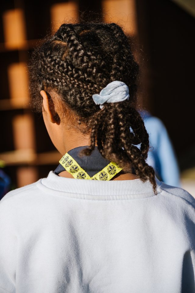 a girl with braids in a white shirt
