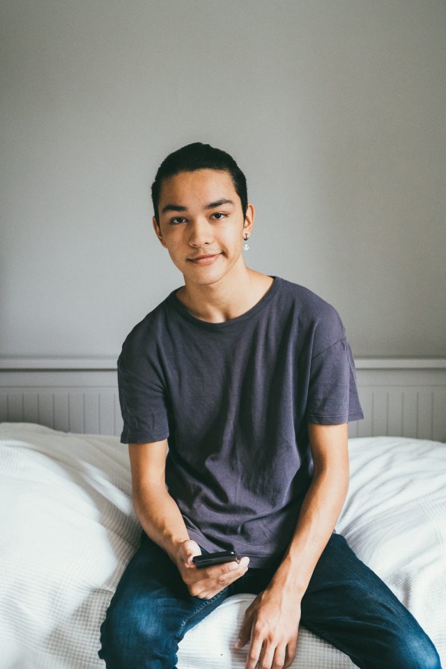 a man sitting on a bed