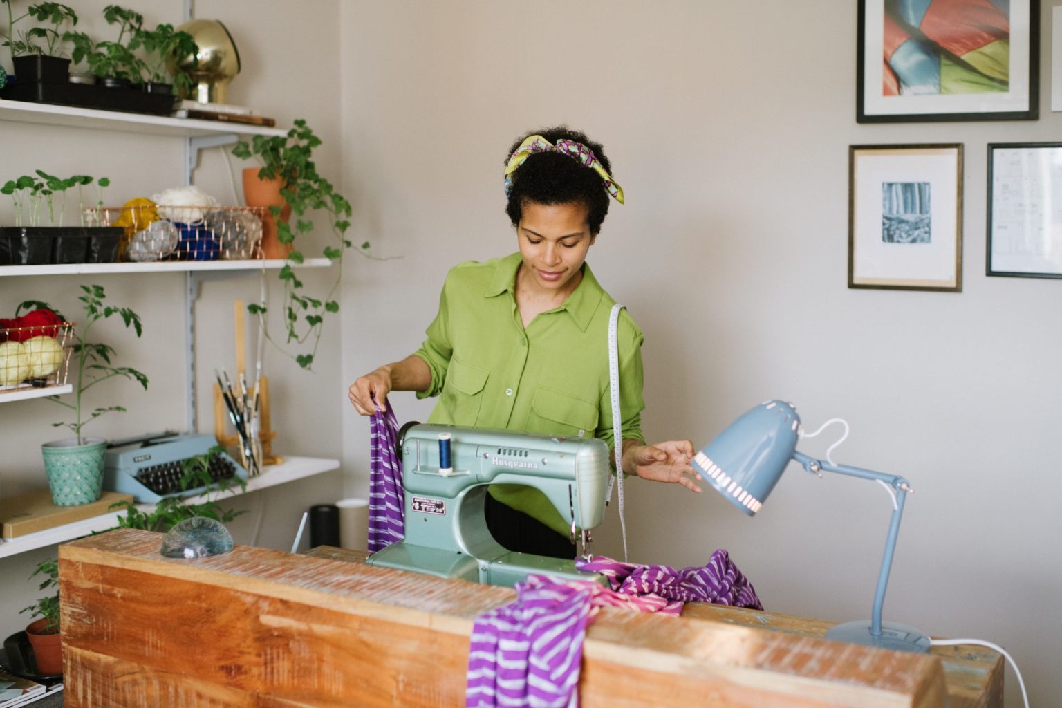a woman sewing on a sewing machine