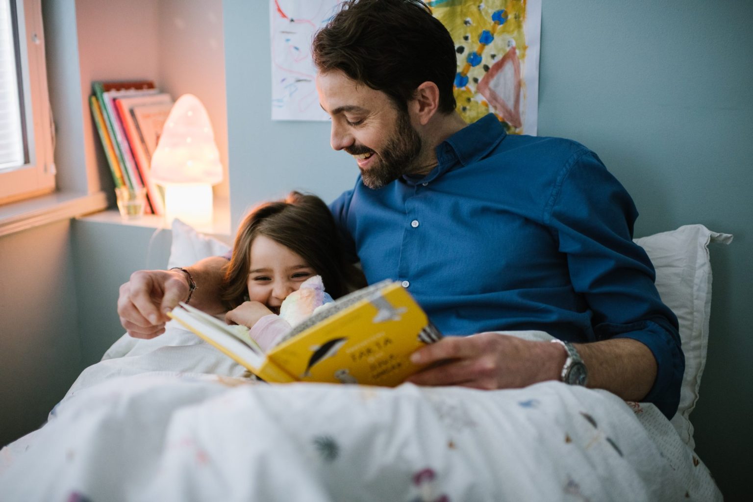 a man and a girl reading a book