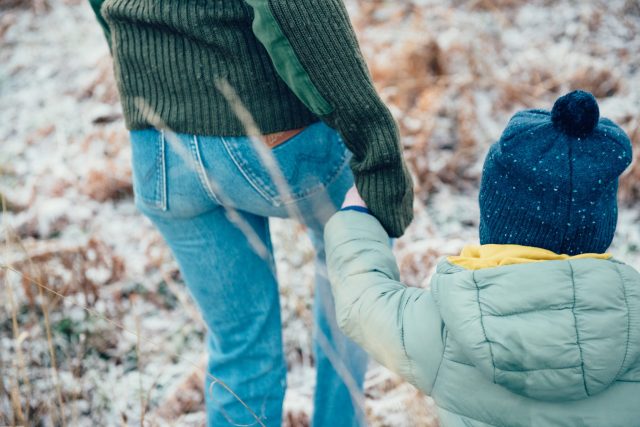 a woman and child holding hands