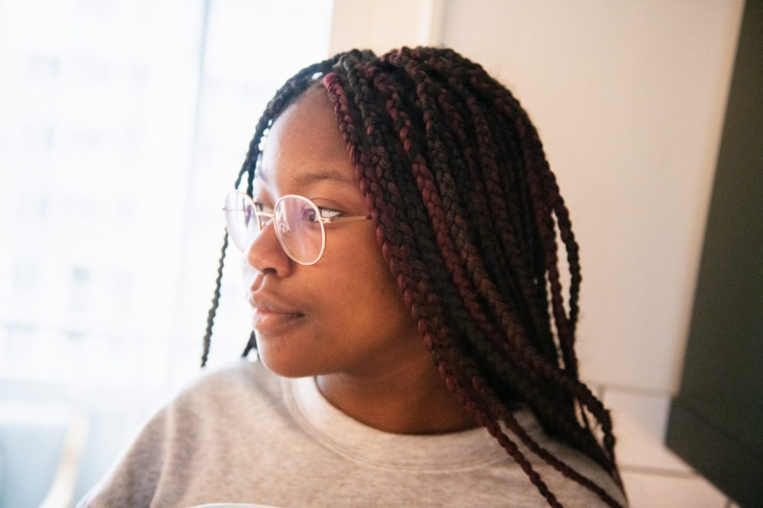 a woman with braids wearing glasses