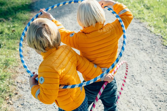 two children holding hula hoops
