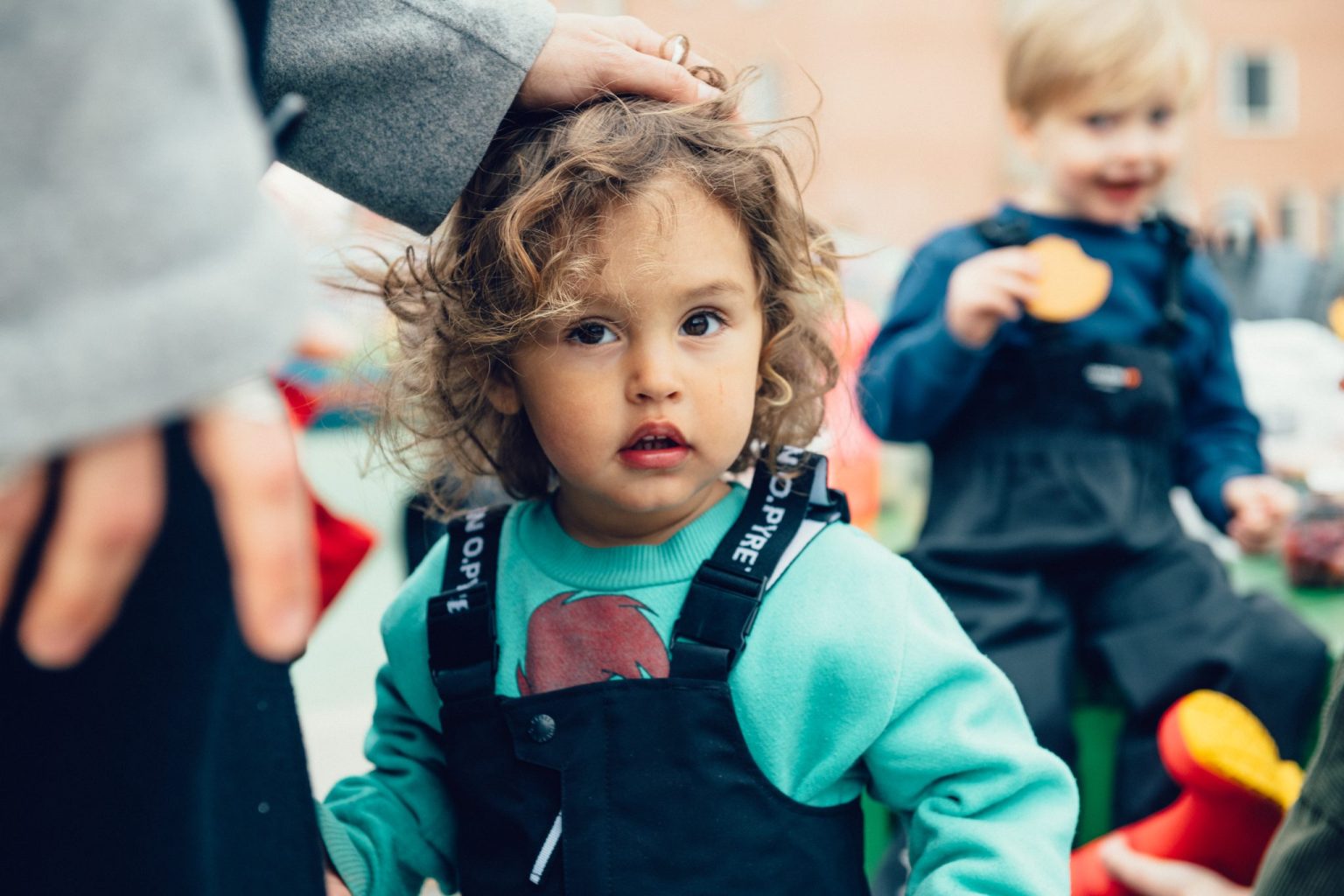 a child with a hand on her head
