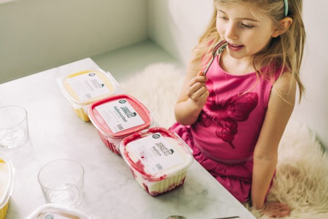 a girl eating dessert with a spoon