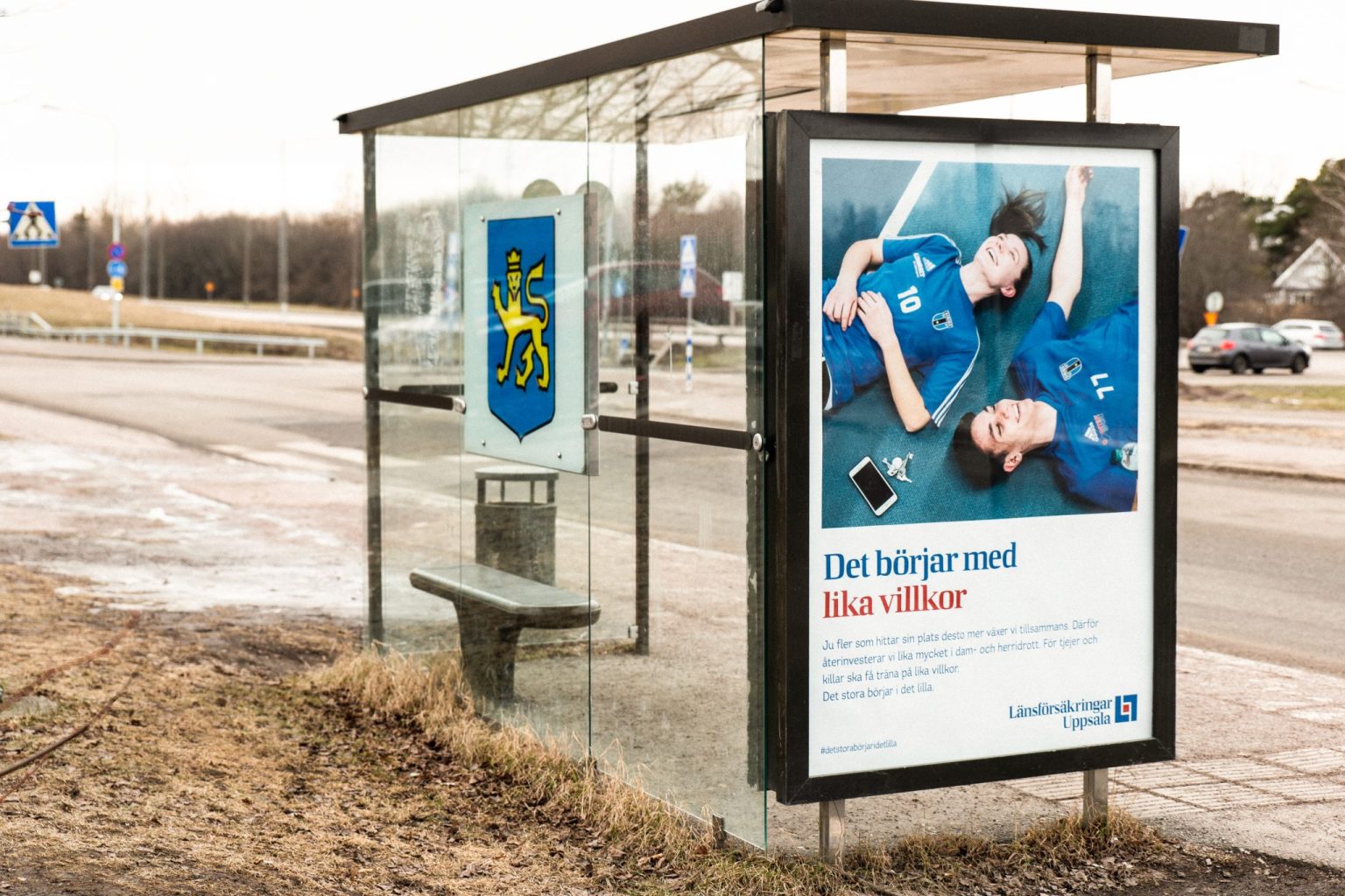 a bus stop with a sign on it