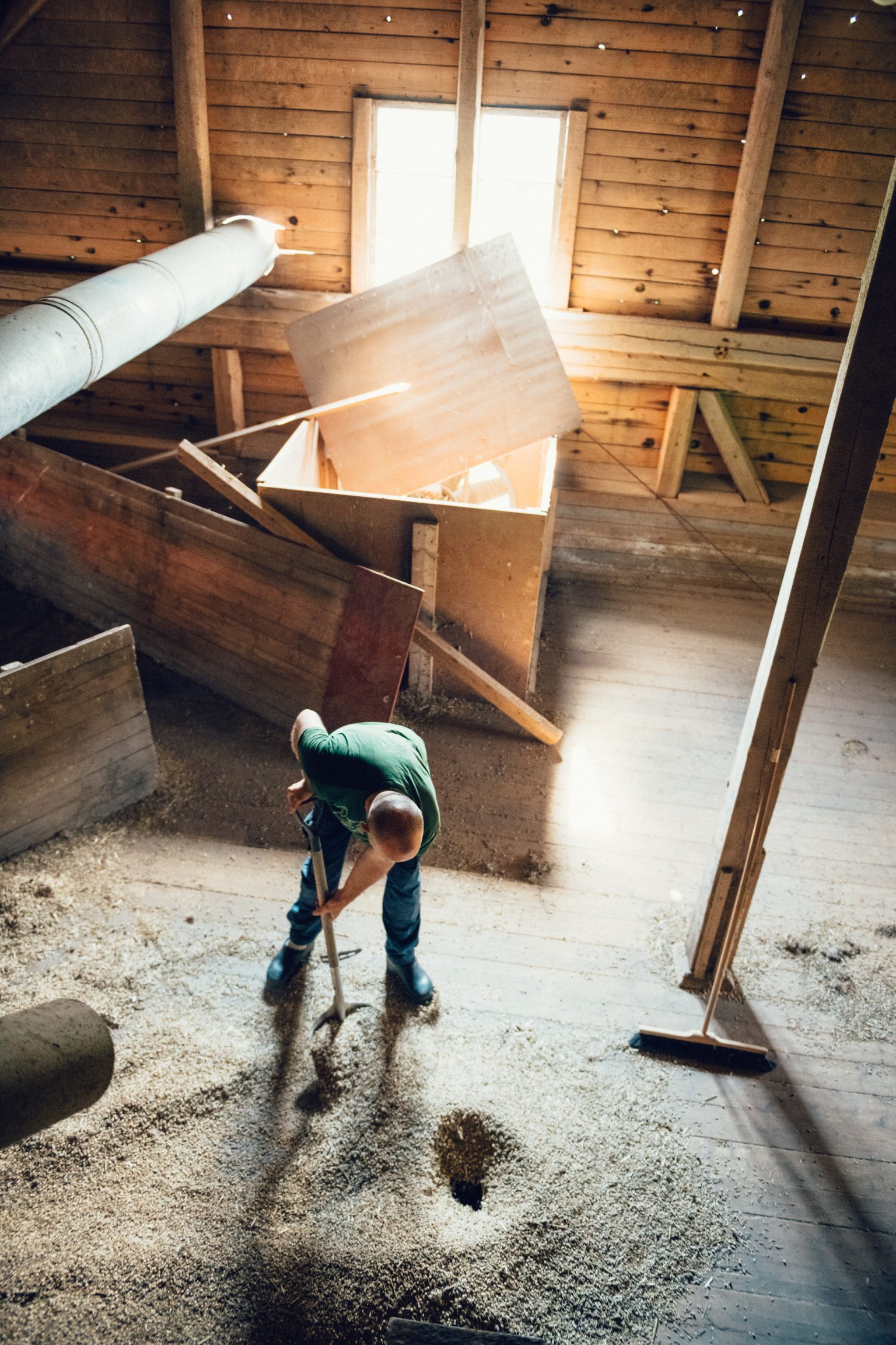 a man cleaning a room with a broom