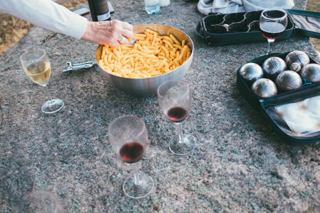 a person holding a bowl of french fries