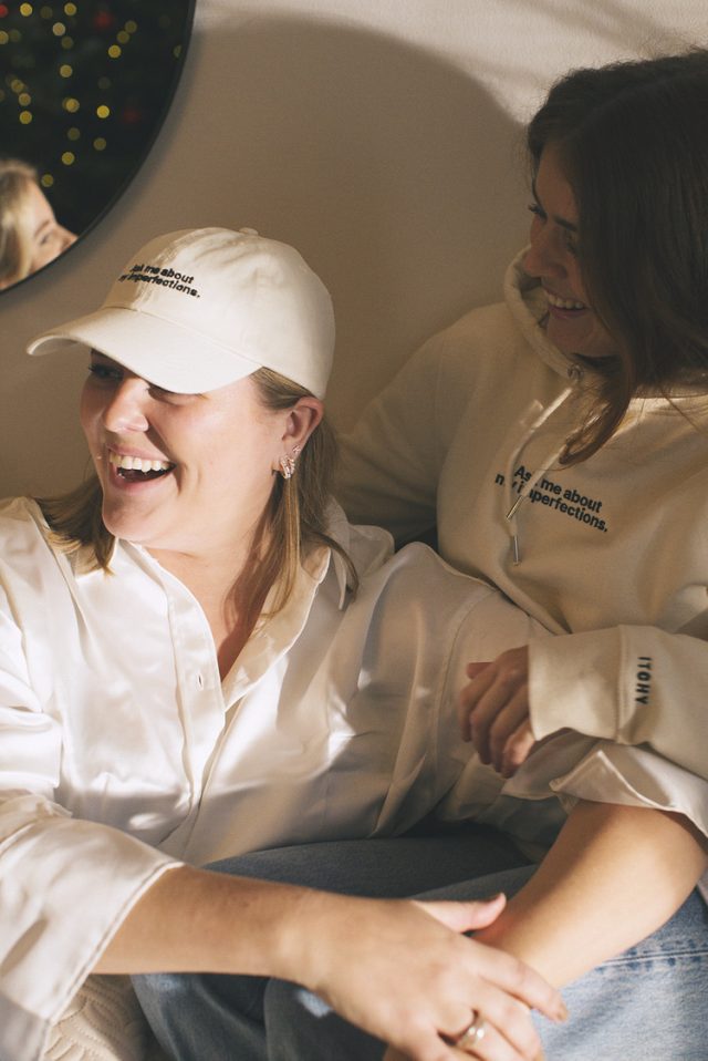 two women wearing white shirts and hats