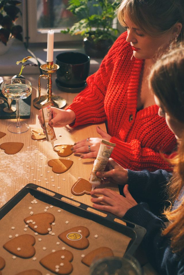 a group of women sitting at a table with cookies