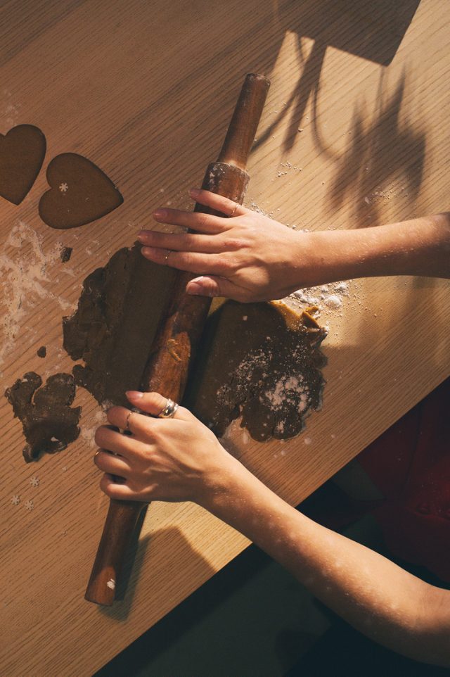 hands rolling dough on a table