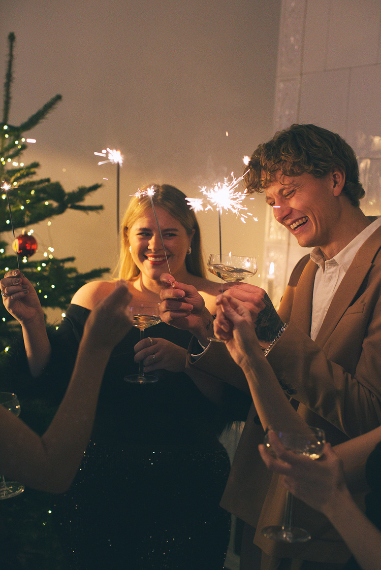 a group of people holding sparklers