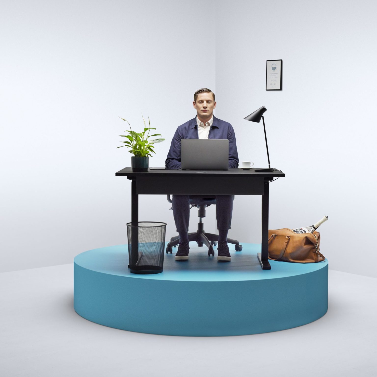 a man sitting at a desk with a laptop