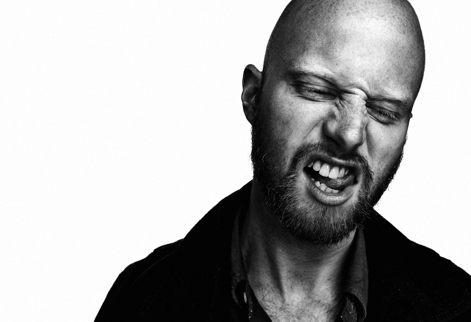 a man with a beard making a face