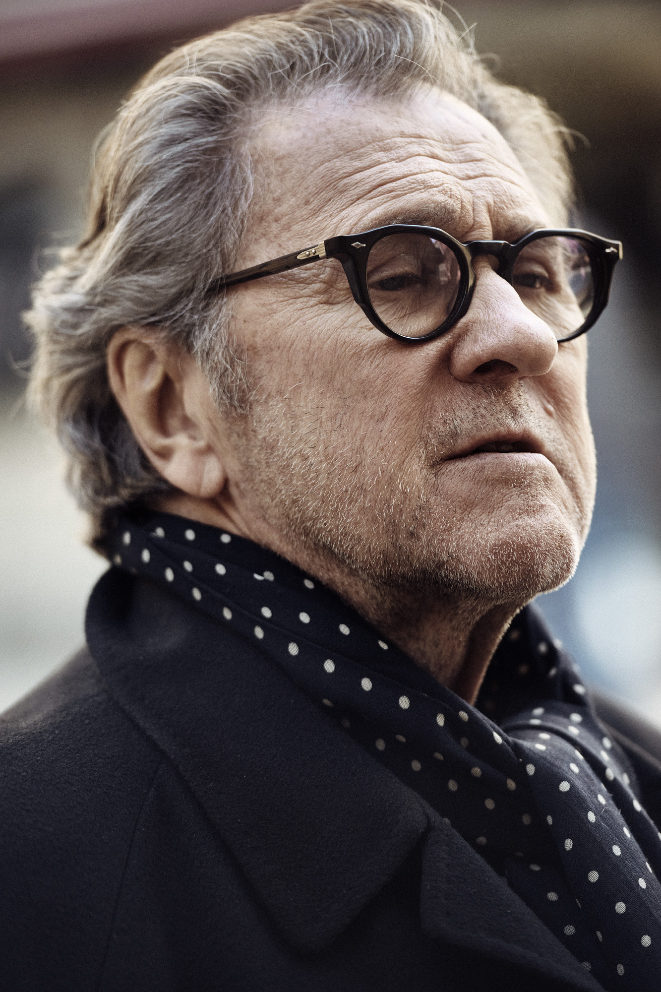 a man wearing glasses and a scarf