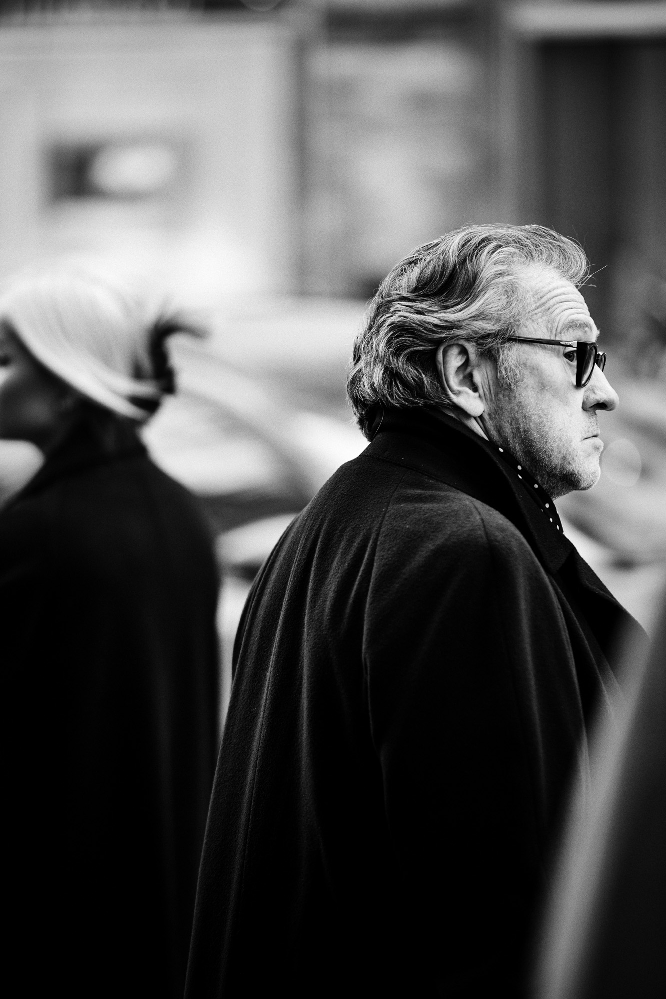a man in a coat and sunglasses