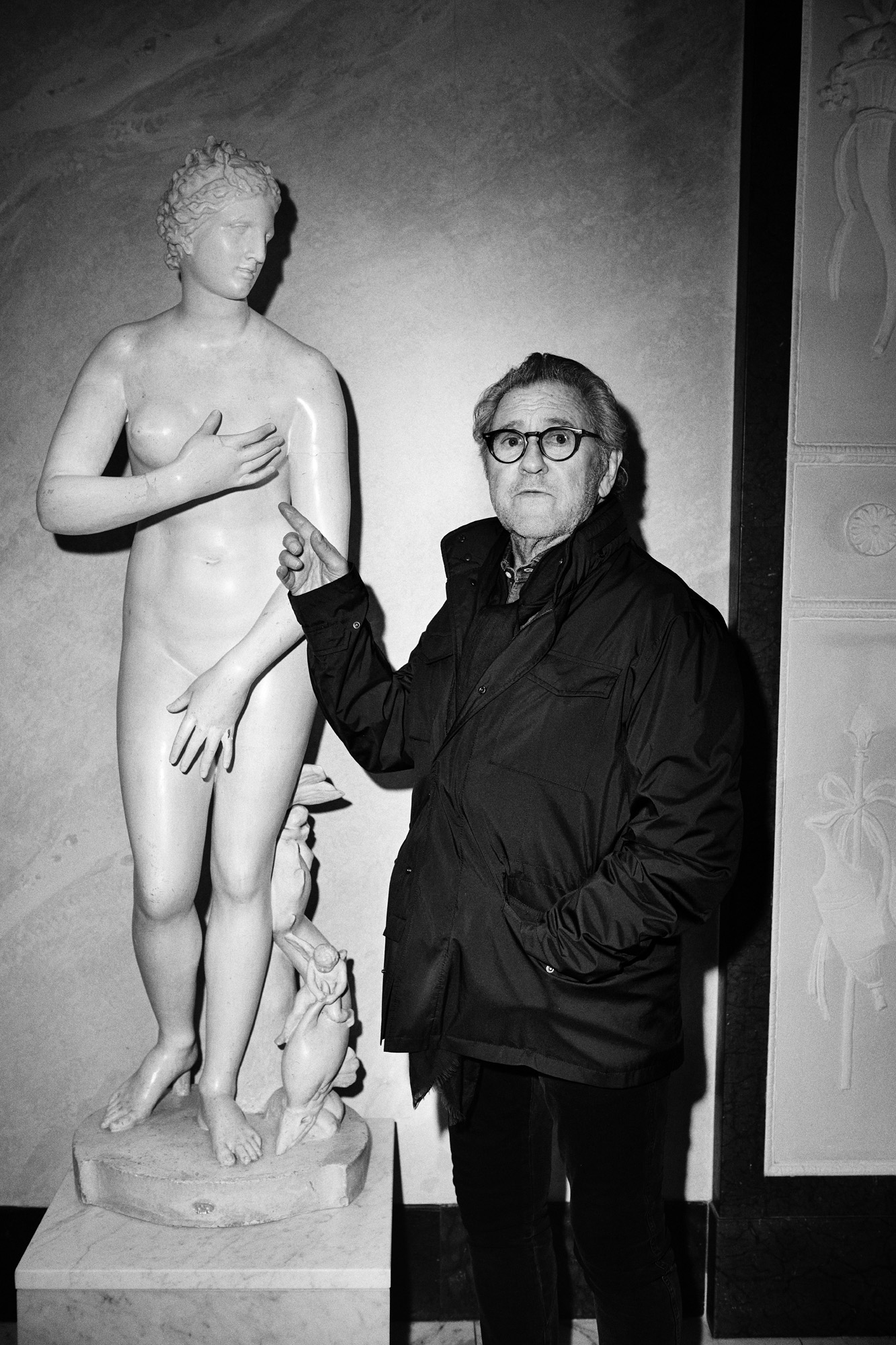 a man standing next to a statue