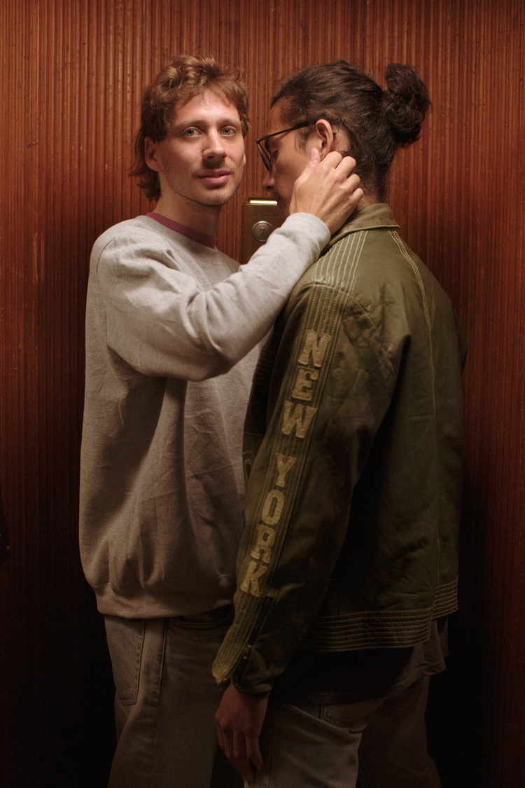 a man holding another man's neck