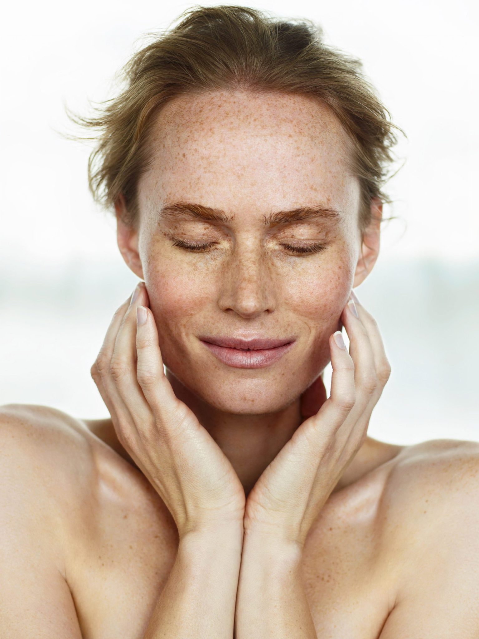 a woman with her eyes closed
