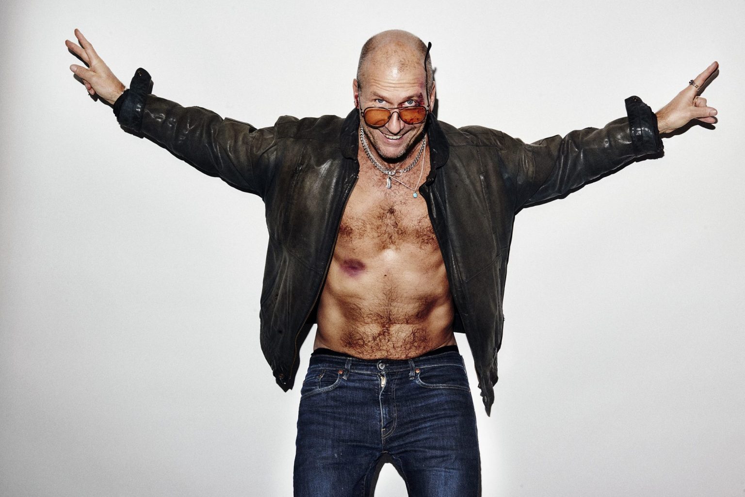 a man with a leather jacket and sunglasses