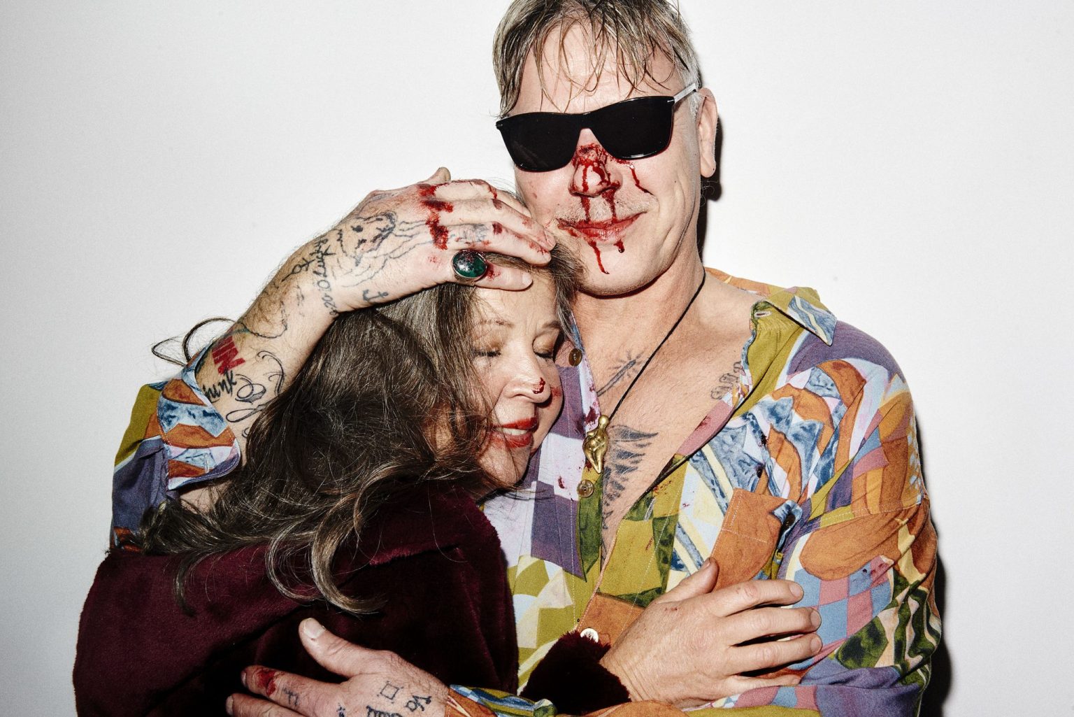 a man and woman with tattoos and face paint