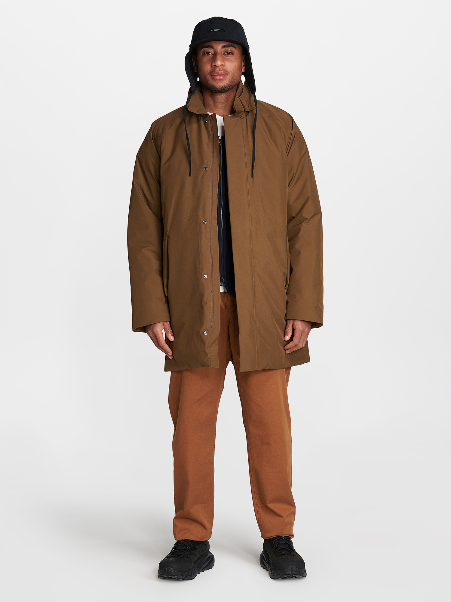 a man wearing a brown jacket