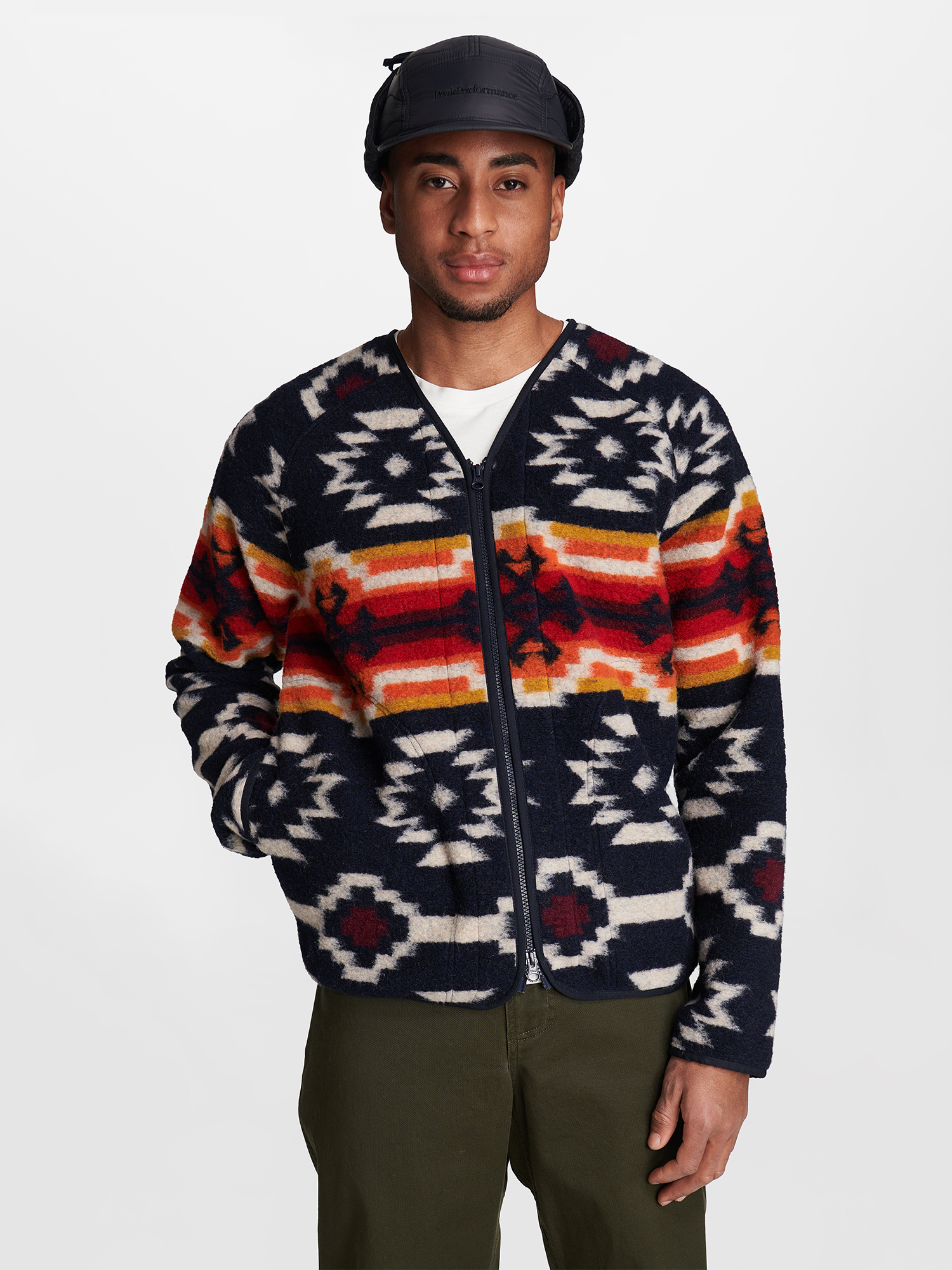 a man wearing a hat and a sweater