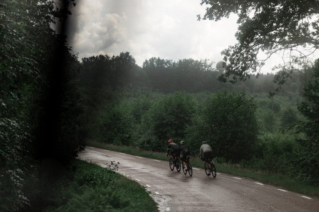 a group of people riding bicycles on a road
