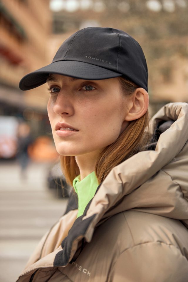 a woman wearing a hat and a jacket