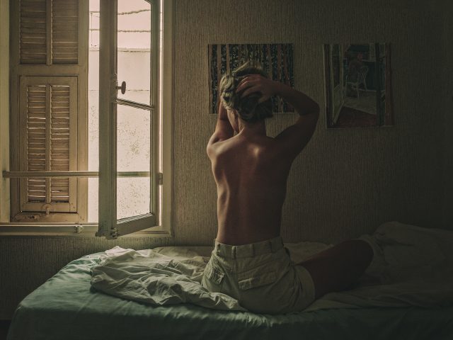 a person sitting on a bed