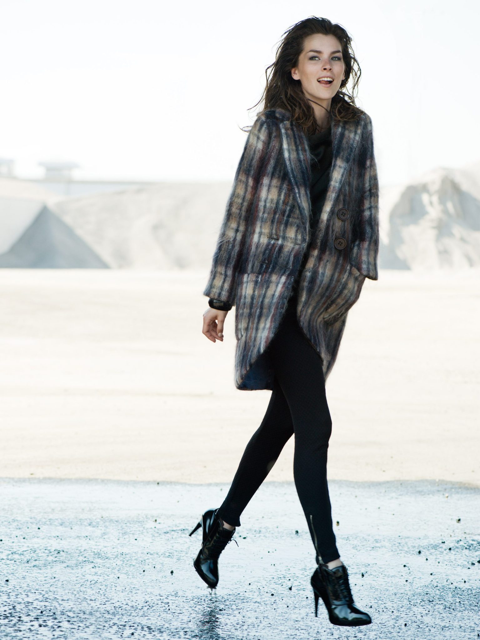 a woman walking in a coat