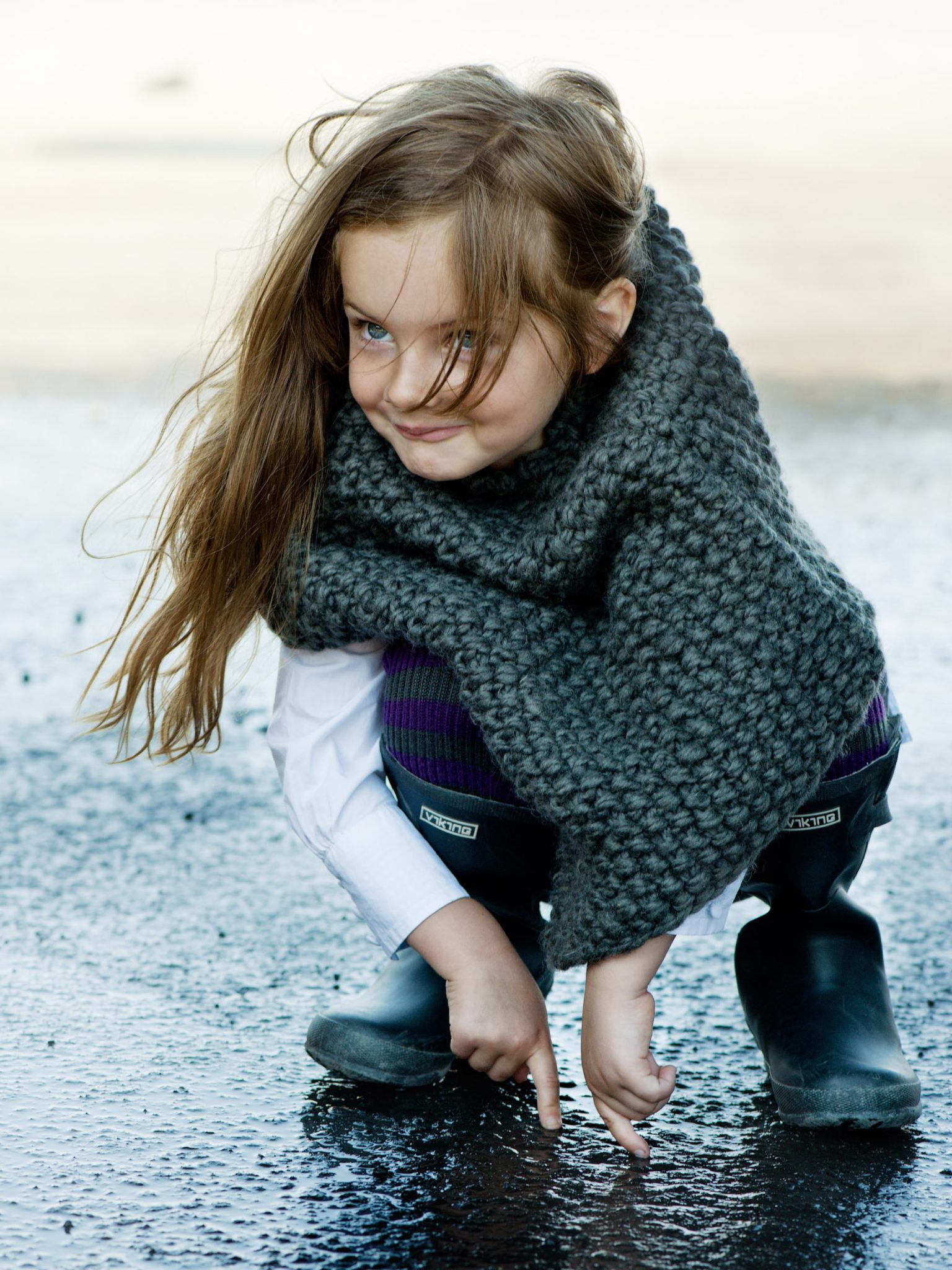 a girl wearing a scarf and boots