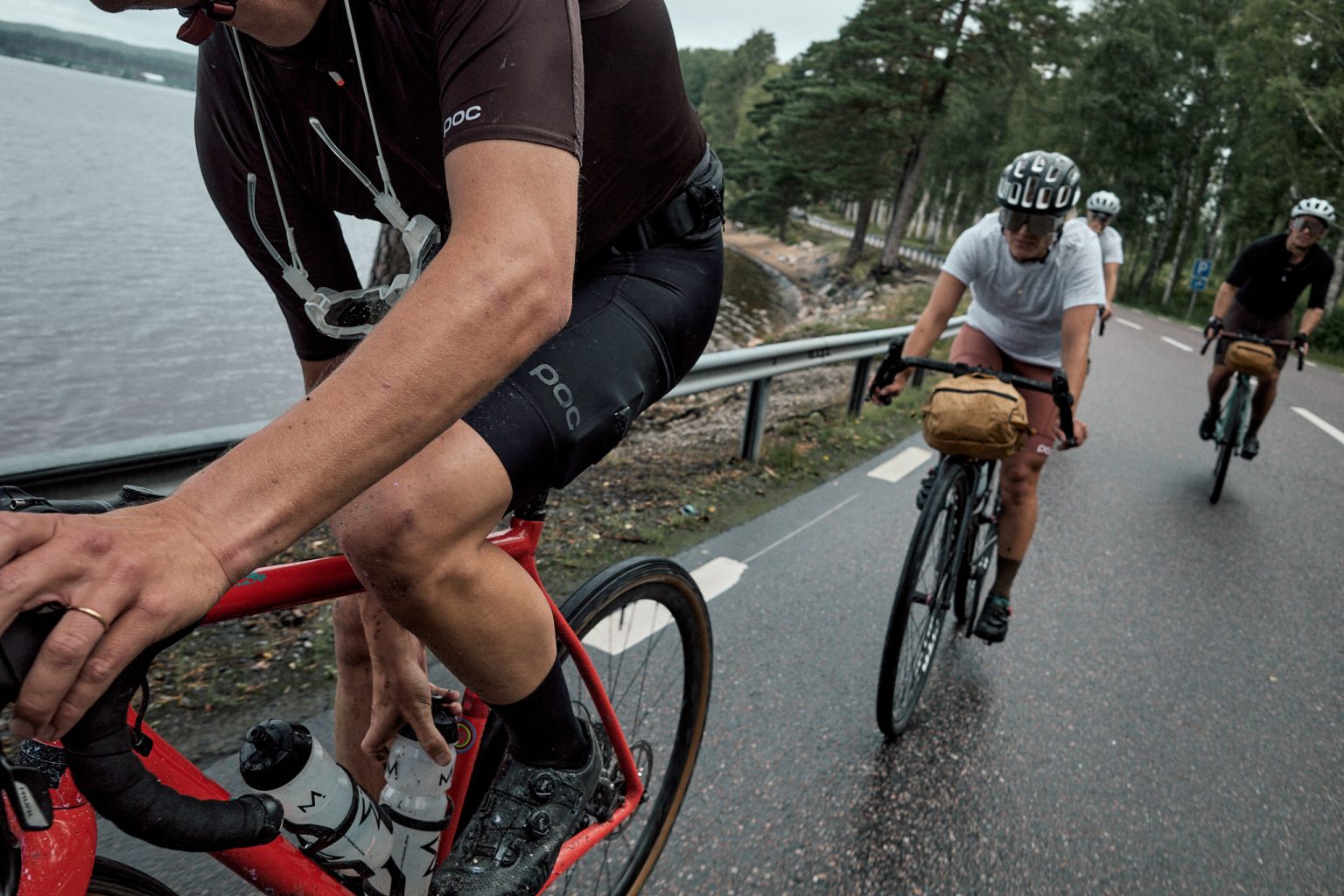 a group of people riding bicycles on a road