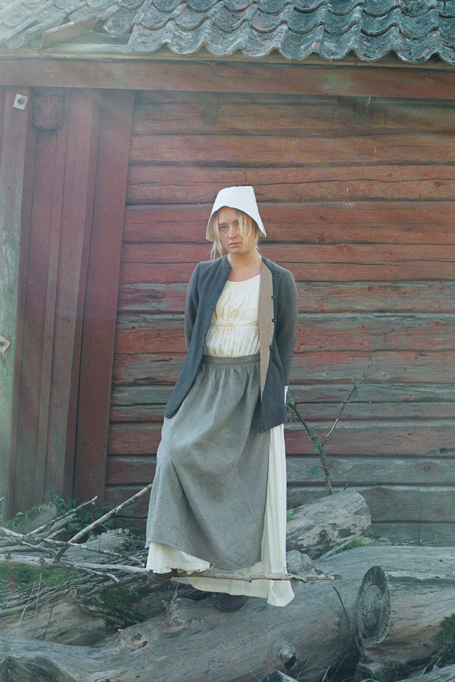 a woman in a white dress and a white hat