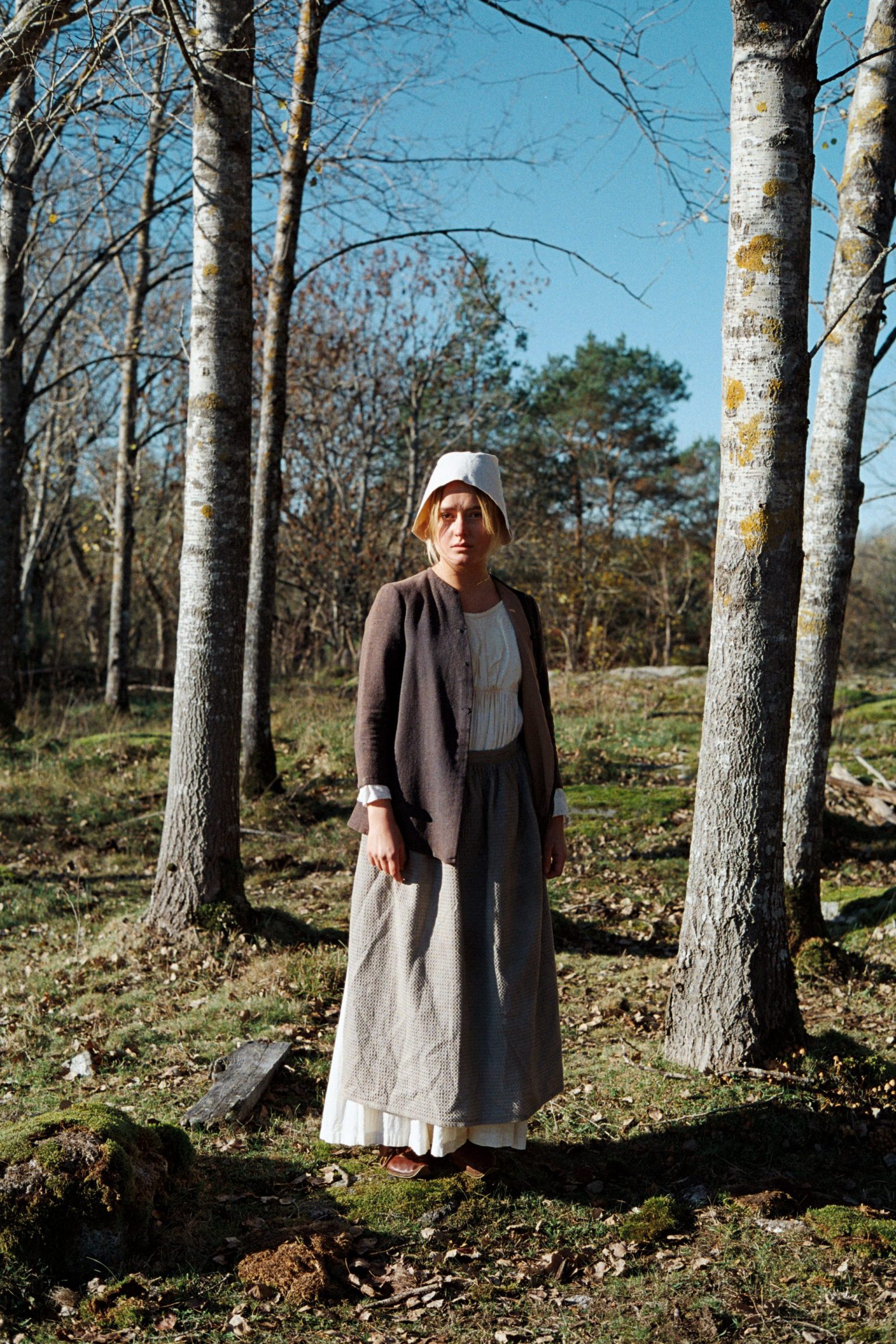 a woman standing in a forest