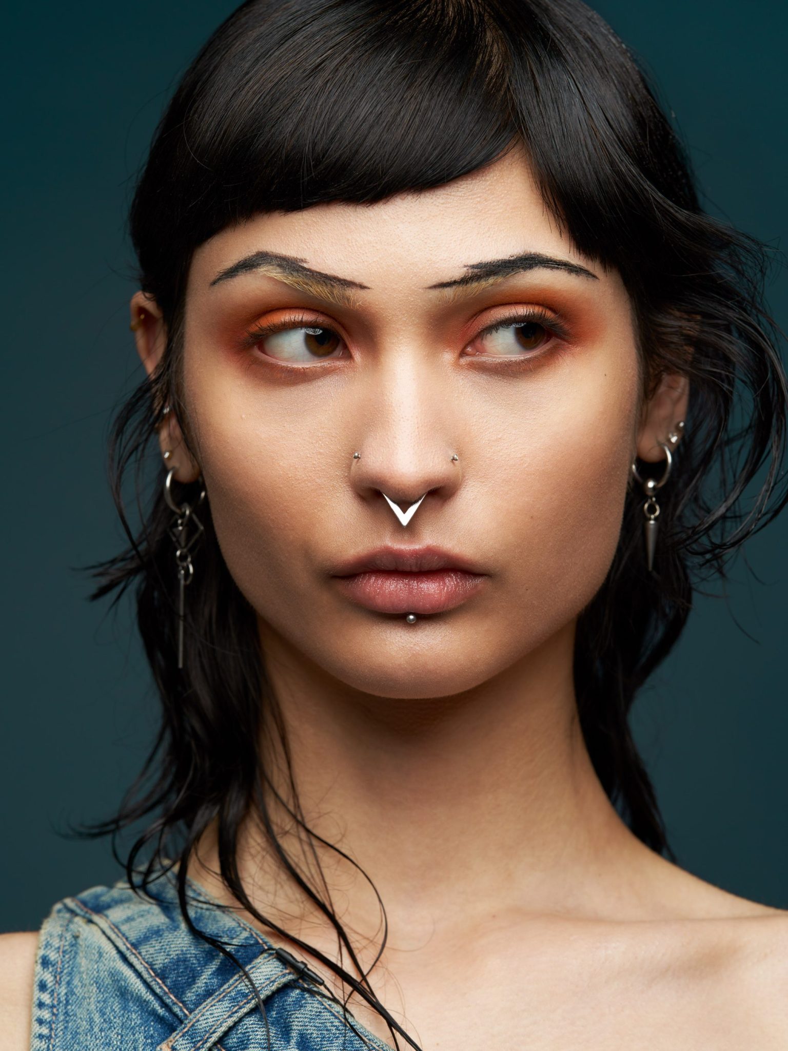 a woman with piercings and earrings