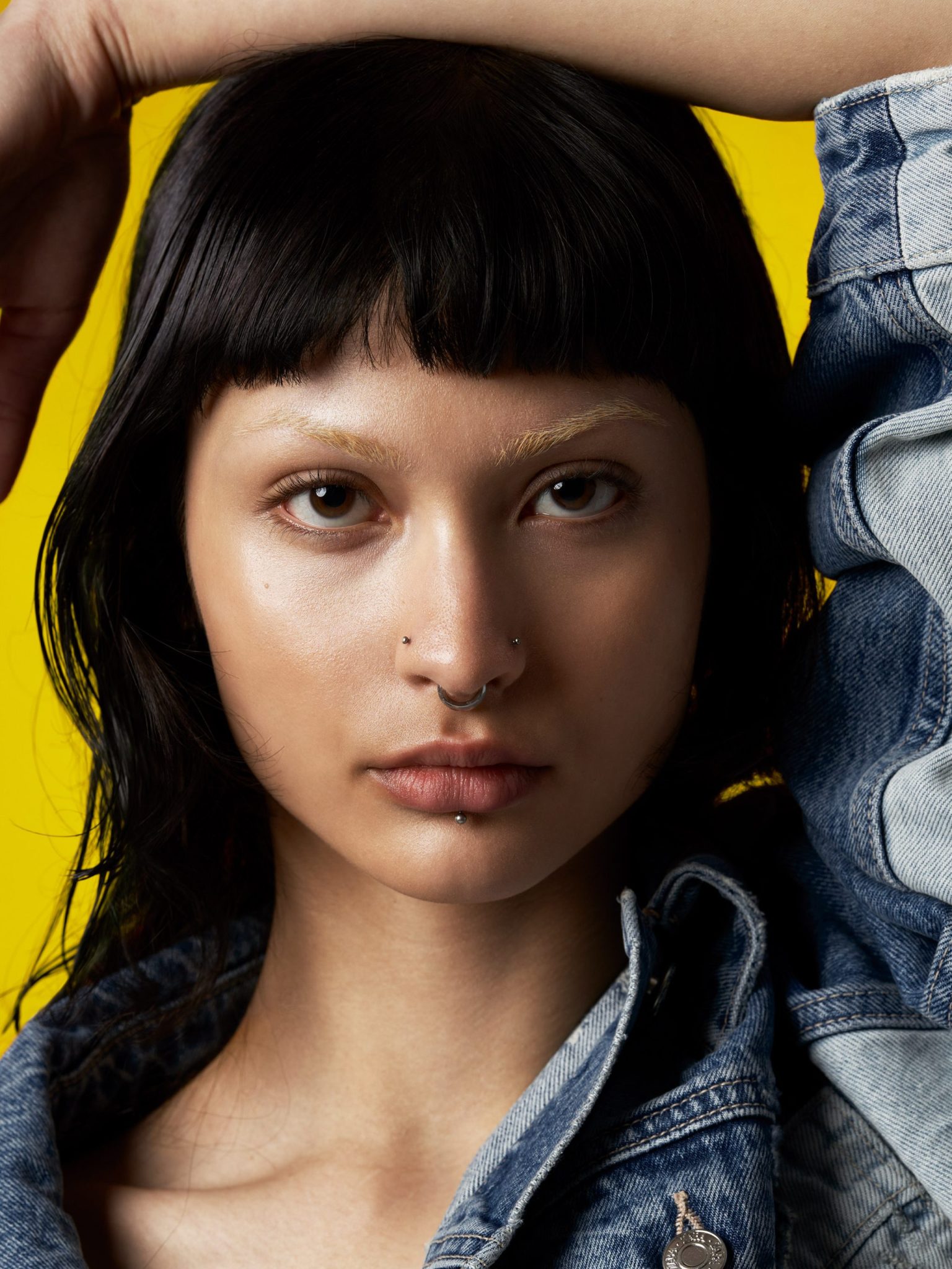 a woman with piercings and nose ring