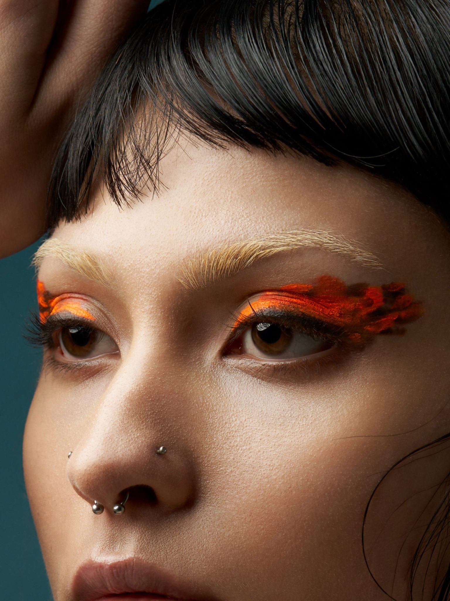a woman with orange and black makeup